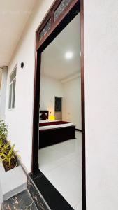 a mirror in a room with a bed at Air Route Transit in Seeduwa