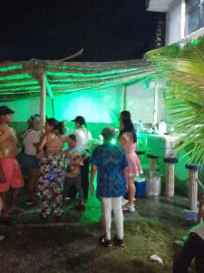 a group of people standing in front of a party at POSADA VSTIKIBAR & RESTAURANt in Rincón del Pirata