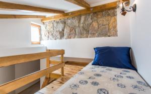 a small bedroom with a bed and a wall at Villa Cima in Vrbnik +38 photos