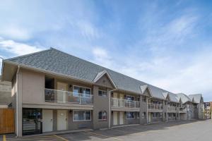 a row of apartments with balconies in a parking lot at Econo Lodge Inn & Suites in Kelowna