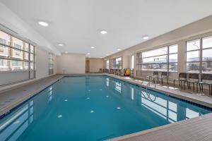 a large swimming pool with blue water in a building at Econo Lodge Inn & Suites in Kelowna