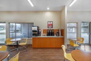 a waiting room with tables and chairs and a counter at Econo Lodge Inn & Suites in Kelowna
