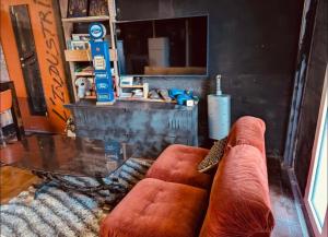 a living room with a couch and a glass table at La Mariefacture - Comme au Garage in Laning
