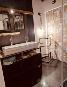 a bathroom with a sink and a shower at La Mariefacture - Comme au Garage in Laning +8 photos