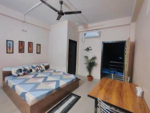 a bedroom with a bed and a table in it at Maddy's Guest House in Guwahati +20 photos