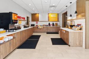 a kitchen with wooden cabinets and a counter in a restaurant at Hampton Inn By Hilton Wharton in Wharton