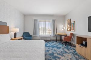 a hotel room with a bed and a desk and chair at Hampton Inn By Hilton Wharton in Wharton +26 photos