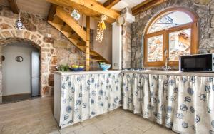 a kitchen with a stone wall at Villa Cima in Vrbnik