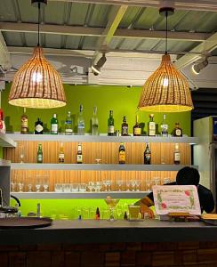 two lights above a bar with bottles of wine at The Upperhouse Hotel Boutique Stay with City & River Views in Cagayan de Oro