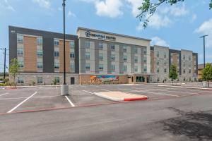 an empty parking lot in front of a large building at Everhome Suites Georgetown - Austin in Georgetown