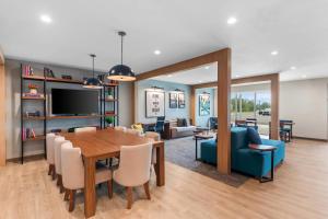 a dining room and living room with a table and chairs at Everhome Suites Georgetown - Austin in Georgetown
