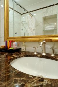 a bathroom with a sink and a mirror at Hotel Villa Duse in Rome