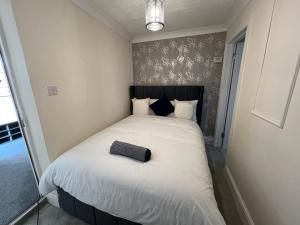 a bed with a black headboard in a room at Summerhill by suspire in Ashford +6 photos