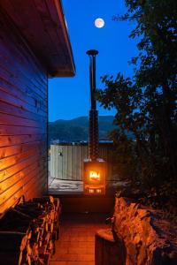 a woodburning stove on the side of a building at Sherpa Pihenőház in Nagymaros