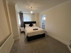a bedroom with a bed and a window at Summerhill by suspire in Ashford