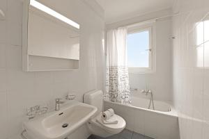 a white bathroom with a sink and a toilet at Bellinzona Center in Bellinzona +14 photos