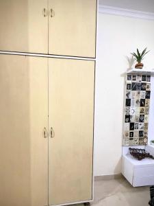 a kitchen with white cabinets and a plant on top at Calm Corner in Panchkula +9 photos