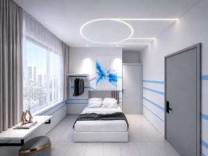 a bedroom with two beds and a large window at One Stop Hotel Ipoh in Ipoh