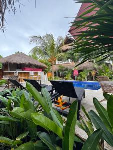 a resort with a pool and some chairs and trees at Dream Makers Retreat in Gili Islands