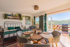 a living room with a bed and a table and chairs at Sherpa Pihenőház in Nagymaros +18 photos