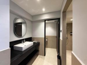 a bathroom with a sink and a mirror at Tropics Eight Suites in George Town +39 photos