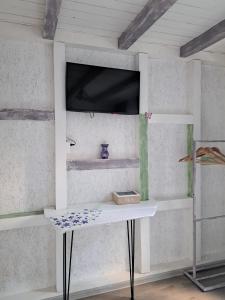 a white table in a room with a window at Căsuța Vesela in Cernişoara +14 photos