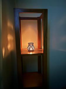 a small vase is sitting on a shelf at Aika Homestay in Pāsighāt