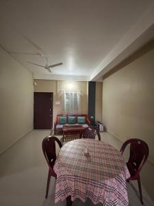a room with a table and chairs and a couch at Aika Homestay in Pāsighāt