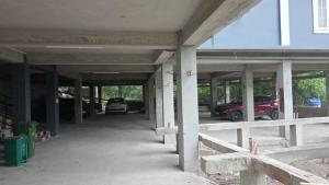 an empty parking garage with cars parked in it at Aika Homestay in Pāsighāt