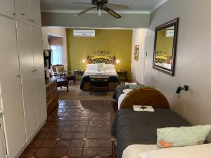 a bedroom with two beds and a room with a bed at Dias Guest House in Bloemfontein +85 photos