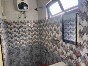 a bathroom with a shower and a toilet and a sink at Dobhanay Homestay in Simāna Basti