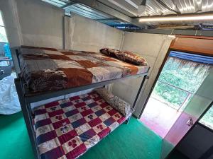 a bed in the back of a train room at Mystic Valley Vattavada in Vattavada
