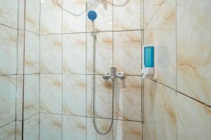 a shower with a shower head in a bathroom at Villa Malakai By ARBA in Palayangan