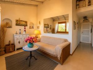 a bedroom with a bed and a table with flowers on it at Amazing Sea View Terrace A with Pool 70m from the Beach in Baja Sardinia