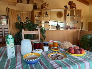 a table with a table cloth with food on it at Casa Poupa in Lagoa
