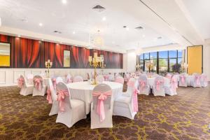 a banquet hall with white tables and pink chairs at Quality Hotel Point Cook in Point Cook +69 photos