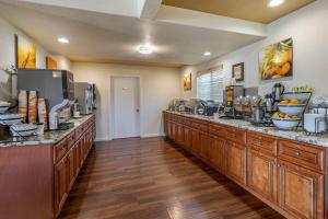 a large kitchen with a long counter with food at Comfort Inn Bishop in Bishop