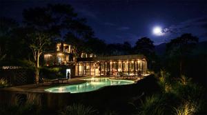 a house with a pool at night with the moon at Inap Retreat Boutique Cabin Kintamani in Kubupenlokan