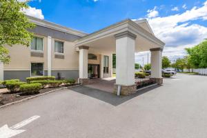 a building with a parking lot in front of it at Quality Inn Edison-New Brunswick in Edison