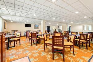 a dining room with wooden tables and chairs at Quality Inn Edison-New Brunswick in Edison