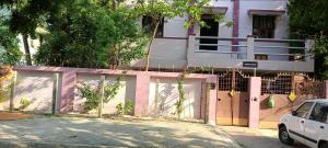 a fence in front of a house with a balcony at Aiswarya illam in Chidambaram