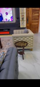 a living room with a couch and a coffee table at Vineyardcourts Apartment in Lagos