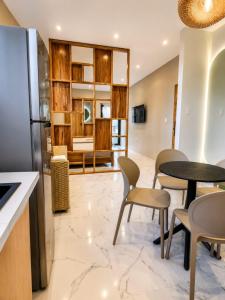 a living room with a table and chairs at Islander Suite in Puerto Baquerizo Moreno +16 photos