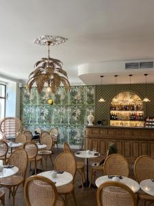 a restaurant with tables and chairs and a bar at Hotel La Villa Nice Victor Hugo in Nice