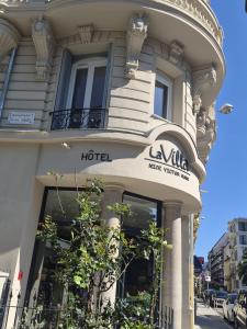a building with a sign on the front of it at Hotel La Villa Nice Victor Hugo in Nice