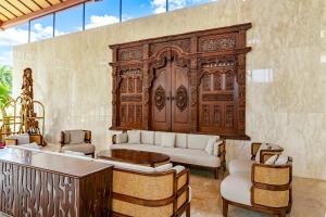 a living room with a couch and a wooden door at NDC Resort & Spa in Manado