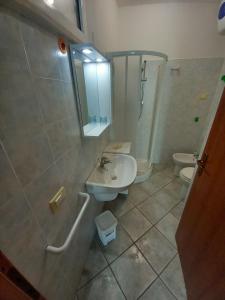 a bathroom with a sink and a shower and a toilet at Residence Loggetta Margherita in San Vincenzo +25 photos