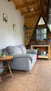 a living room with a couch and a table at Glamping MORET Tiny House M1 in Los Lirios