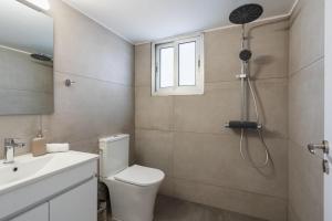 a bathroom with a toilet and a sink and a shower at Elegant City Central Suite in Nicosia