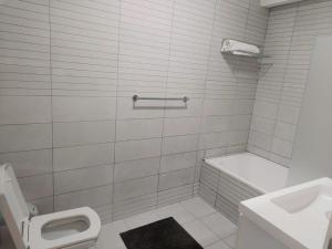 a white bathroom with a toilet and a sink at Farms Fintas - Family Only in Kuwait +8 photos